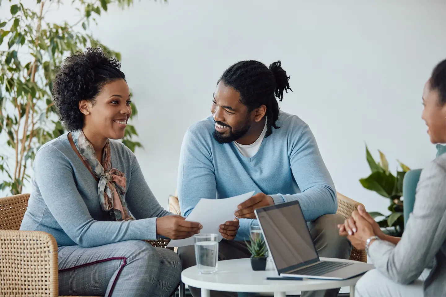 Happy black couple having meeting with their financial advisor in the office.