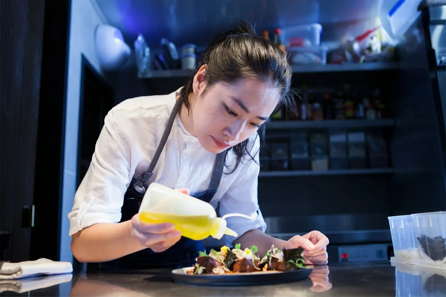 Chef dressing prepared meal