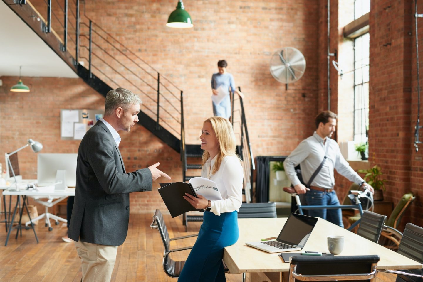 I see you received the report I sent. Shot of businesspeople having a discussion in a busy office.