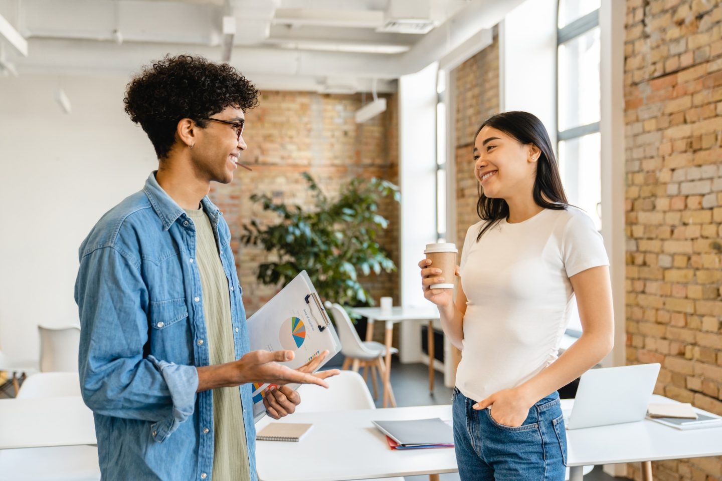 Two business partners having discussion during work break in office