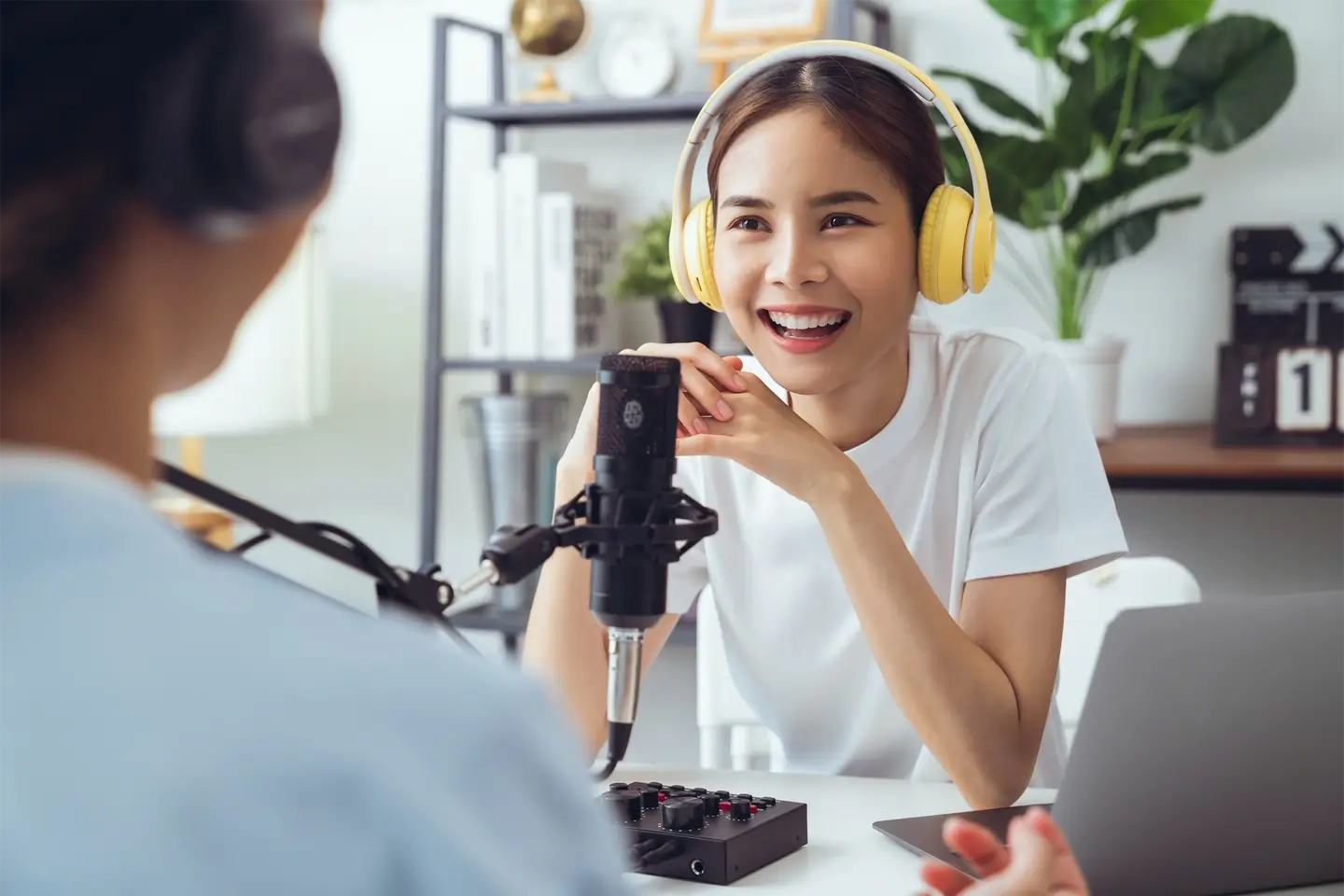 woman use microphones wear headphones with laptop record podcast for radio. Content creator concept.