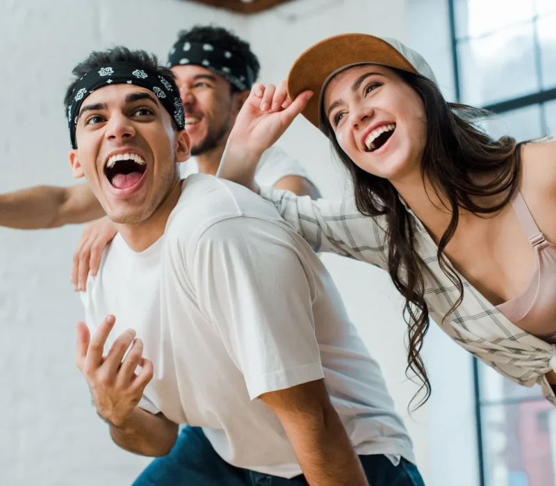 selective-focus-of-cheerful-multicultural-dancers-laughing-in-dance-studio.webp