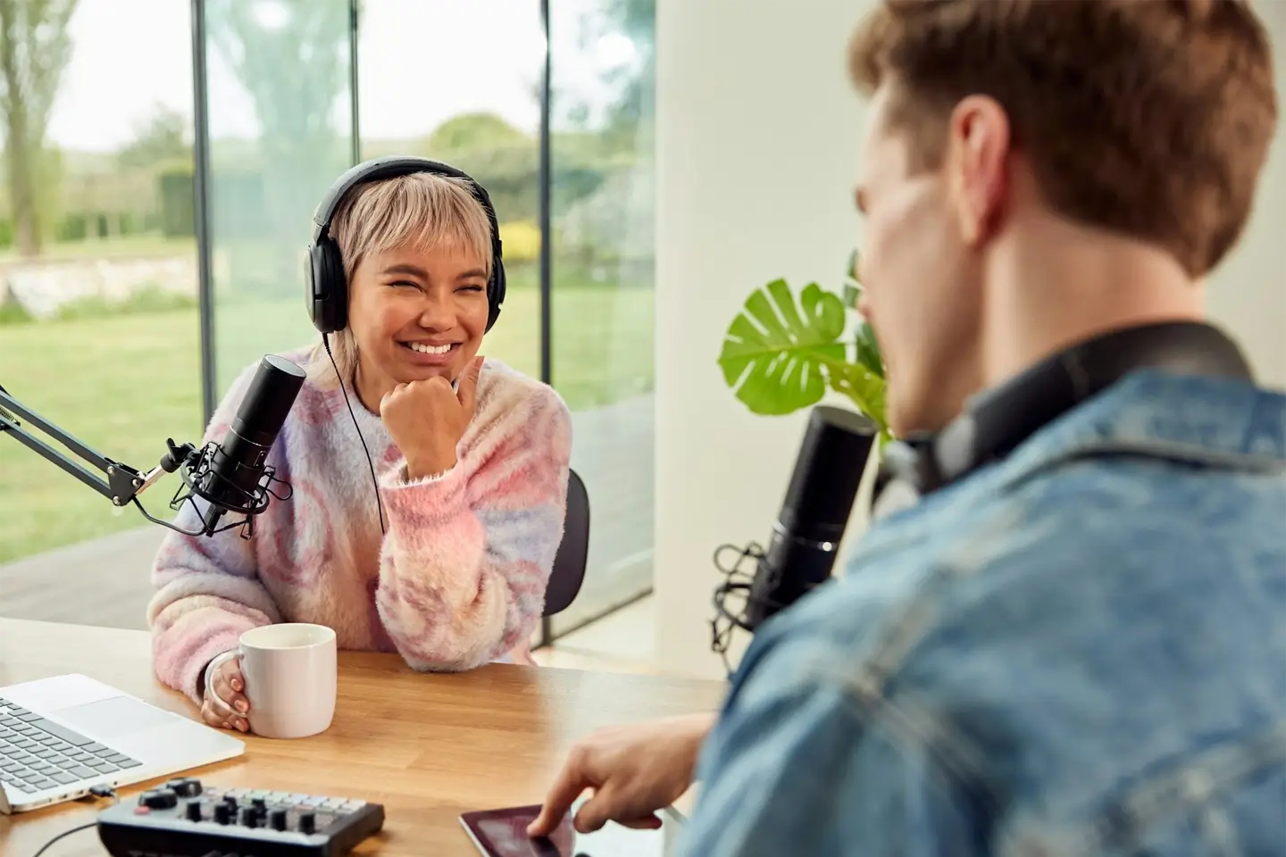 Couple Recording Podcast Or Broadcasting Interview On Radio In Studio At Home With Laptop