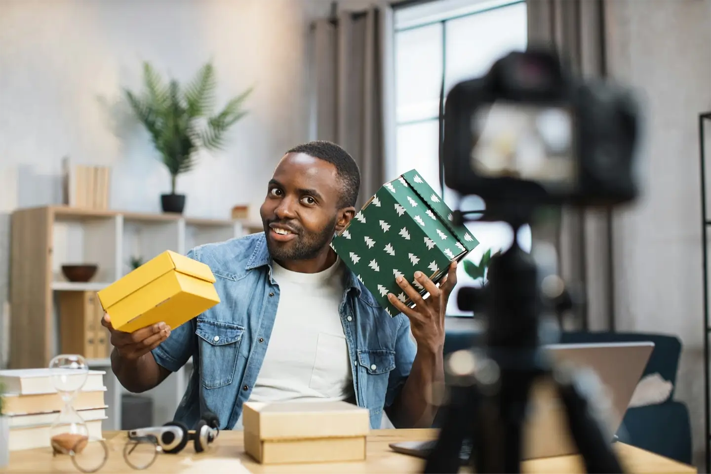 Male influencer doing live stream while opening presents