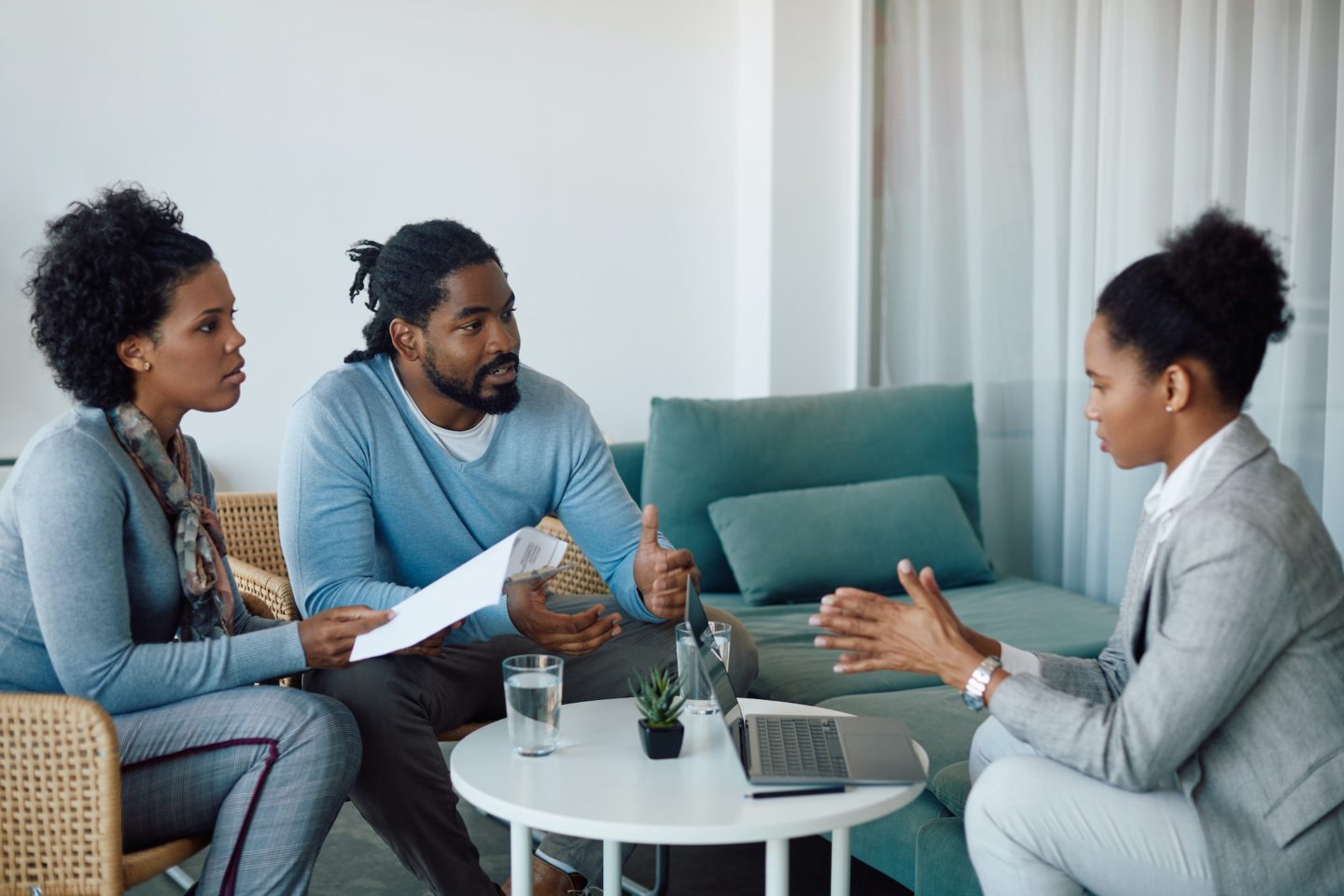 African American couple communicating with their insurance agent during a meeting in the office.