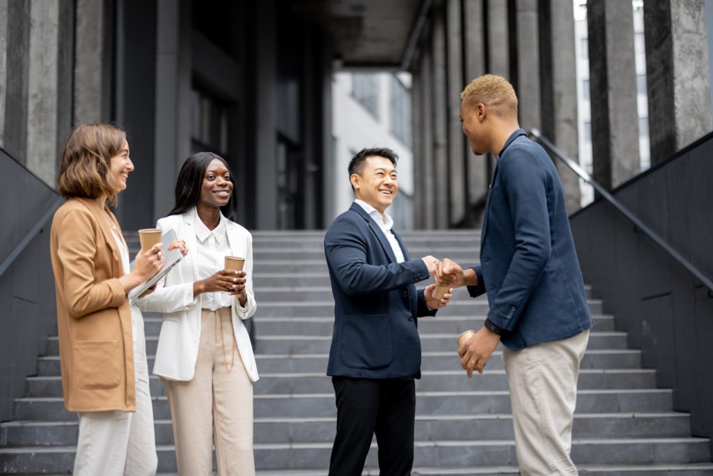 Multiracial business team bumping fists each other