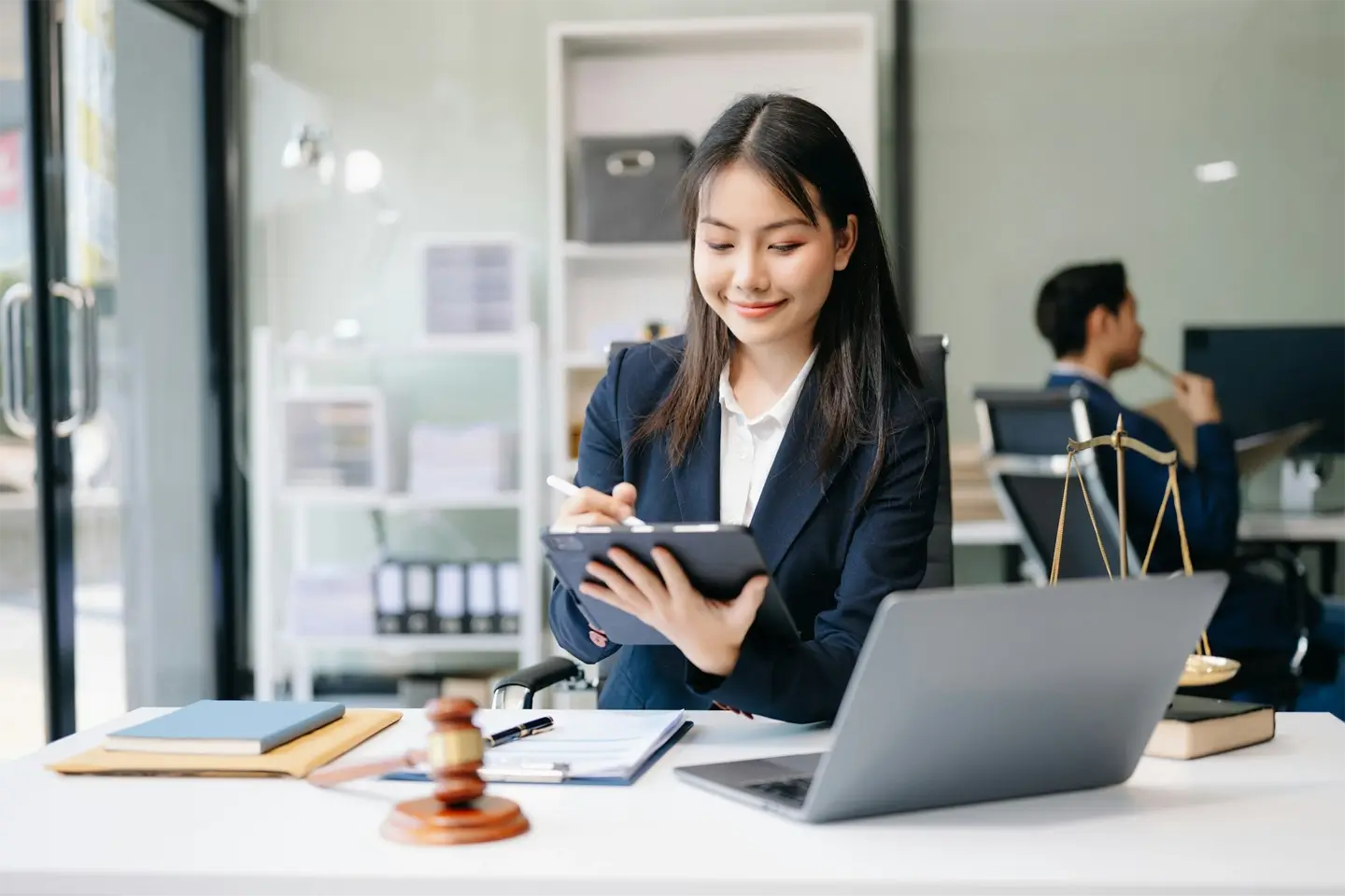 Asian woman lawyer working and gavel, tablet, laptop in front, Advice justice and law concept.