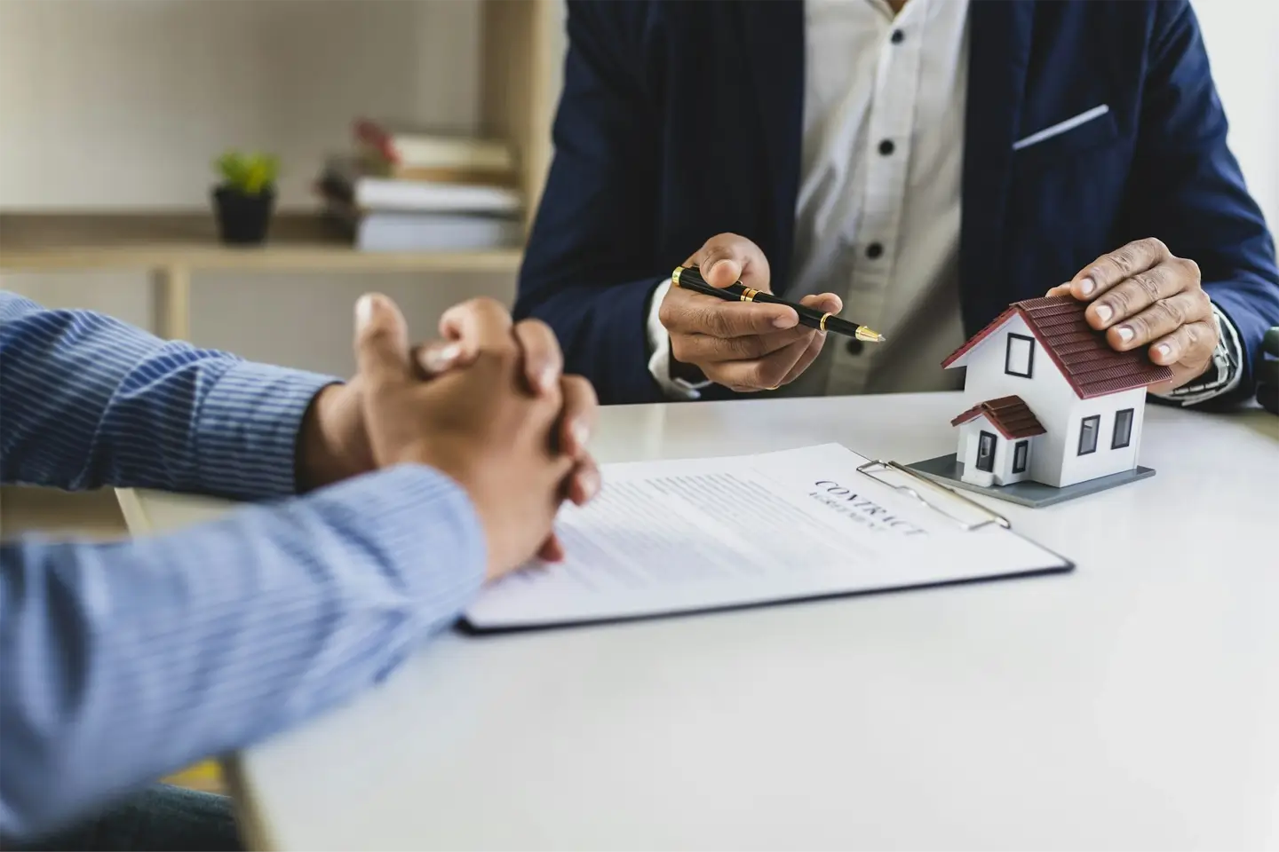 real estate agent explaining the terms in the legal real estate agreement contract document.