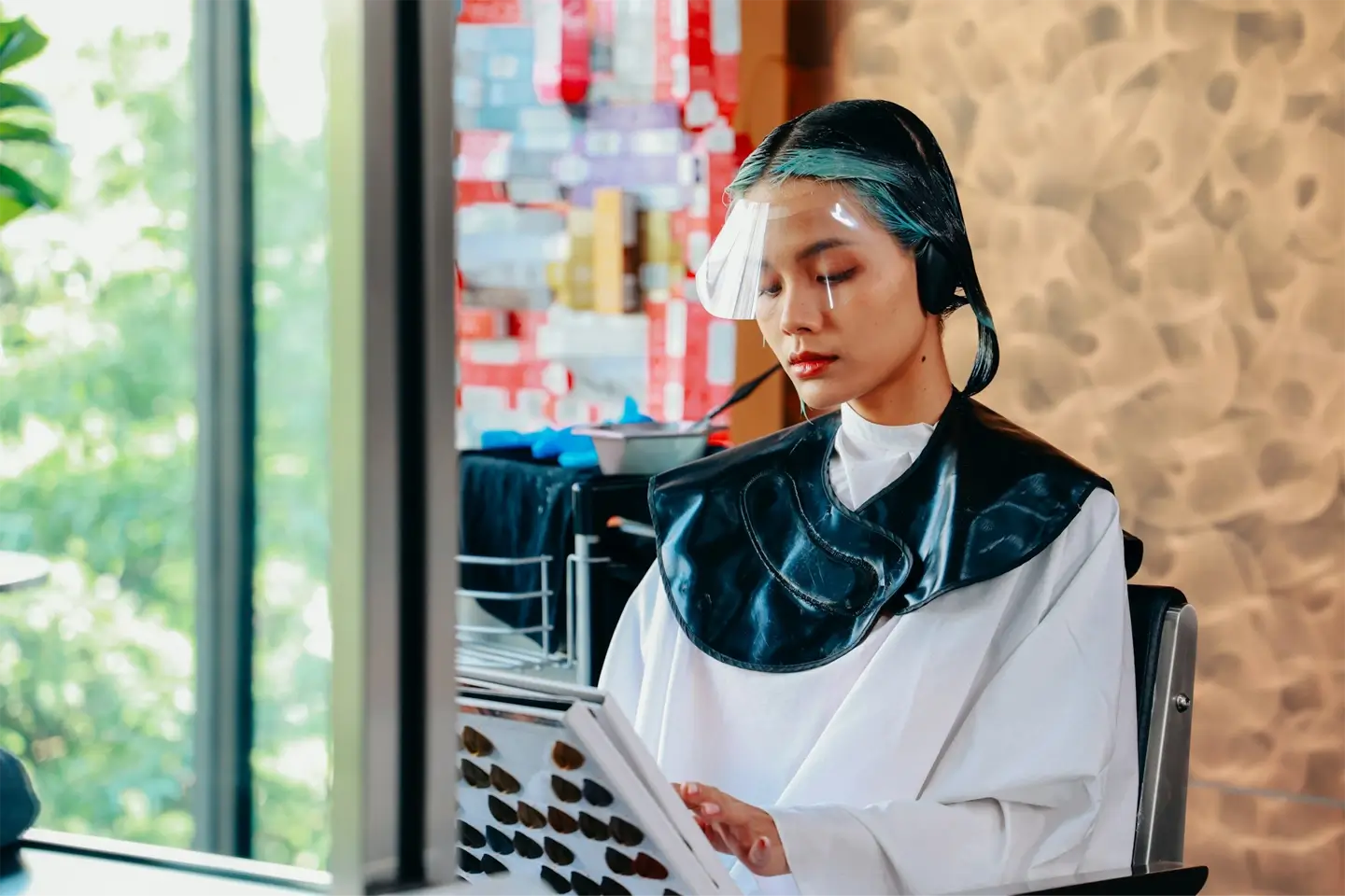 Woman deciding hair colour shade in salon