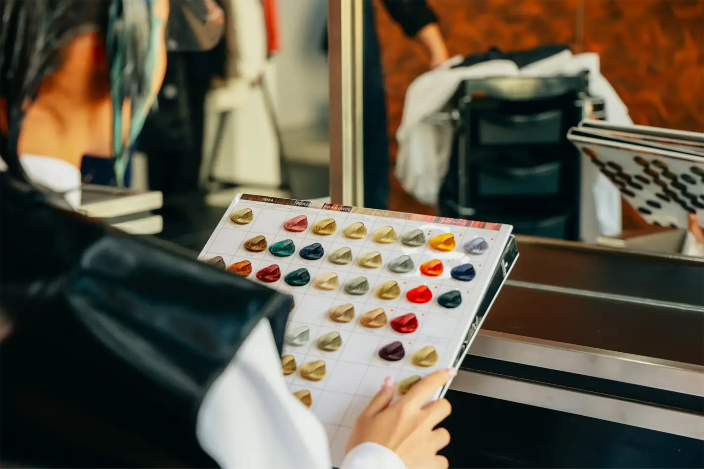 Woman deciding hair colour shade in salon