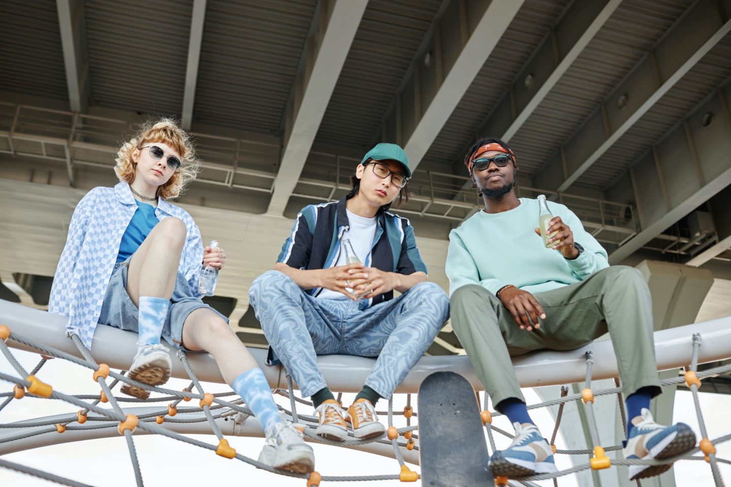 Diverse group of three young people hanging out in urban setting