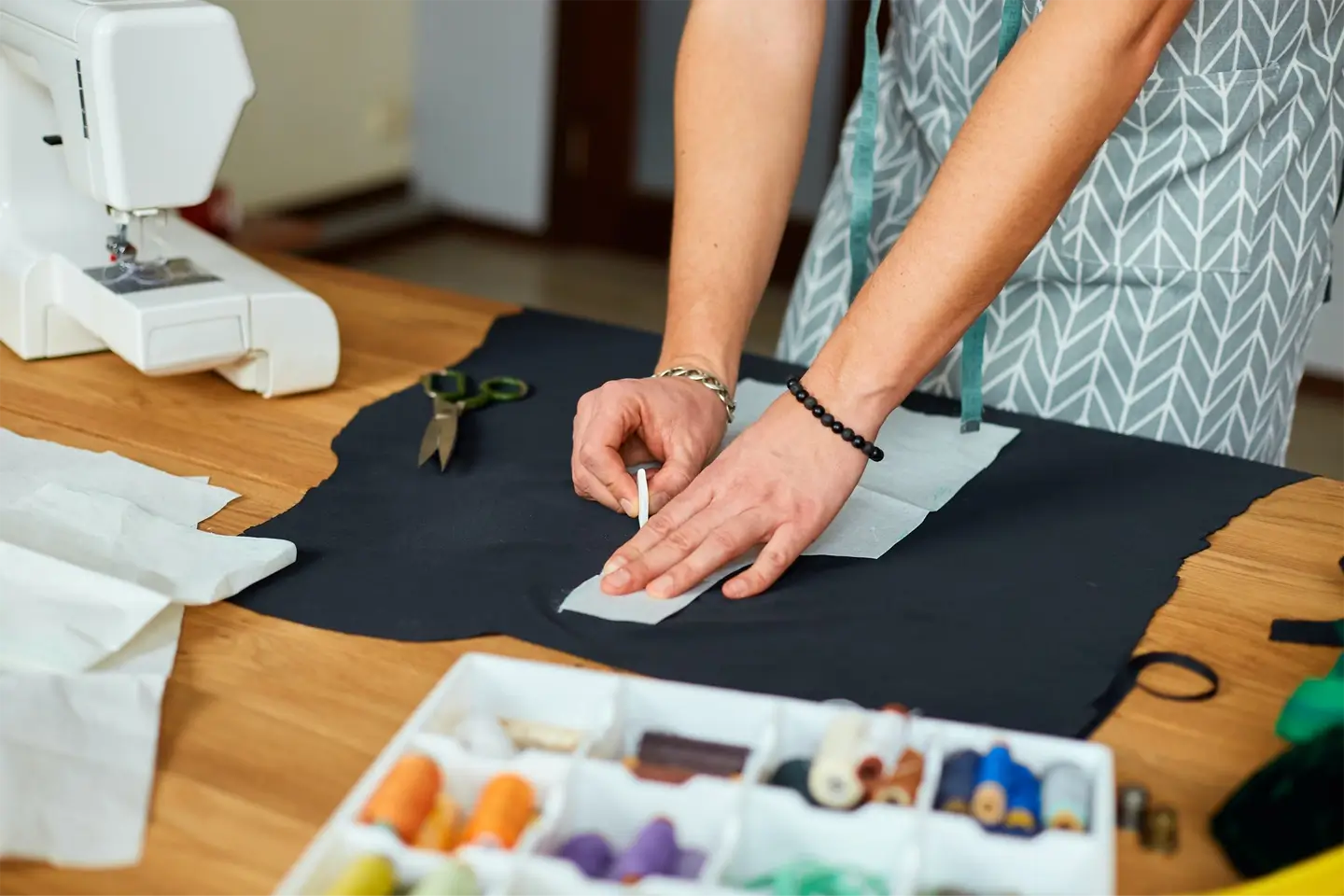 Man dressmaker making sewing patterns, male tailor working with sewing pattern in atelier