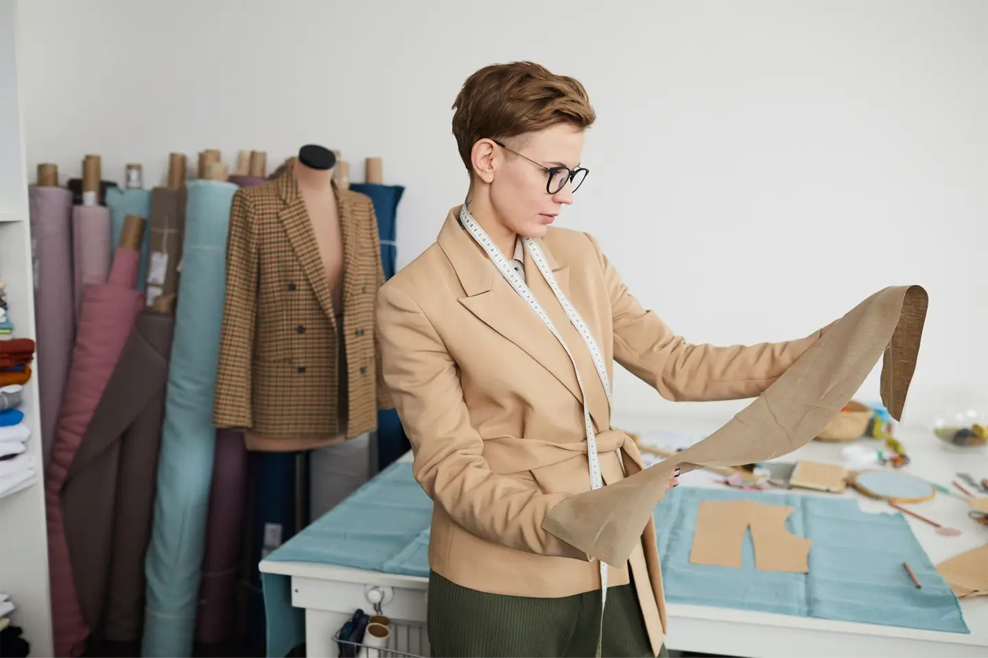 Tailor examining the fabric