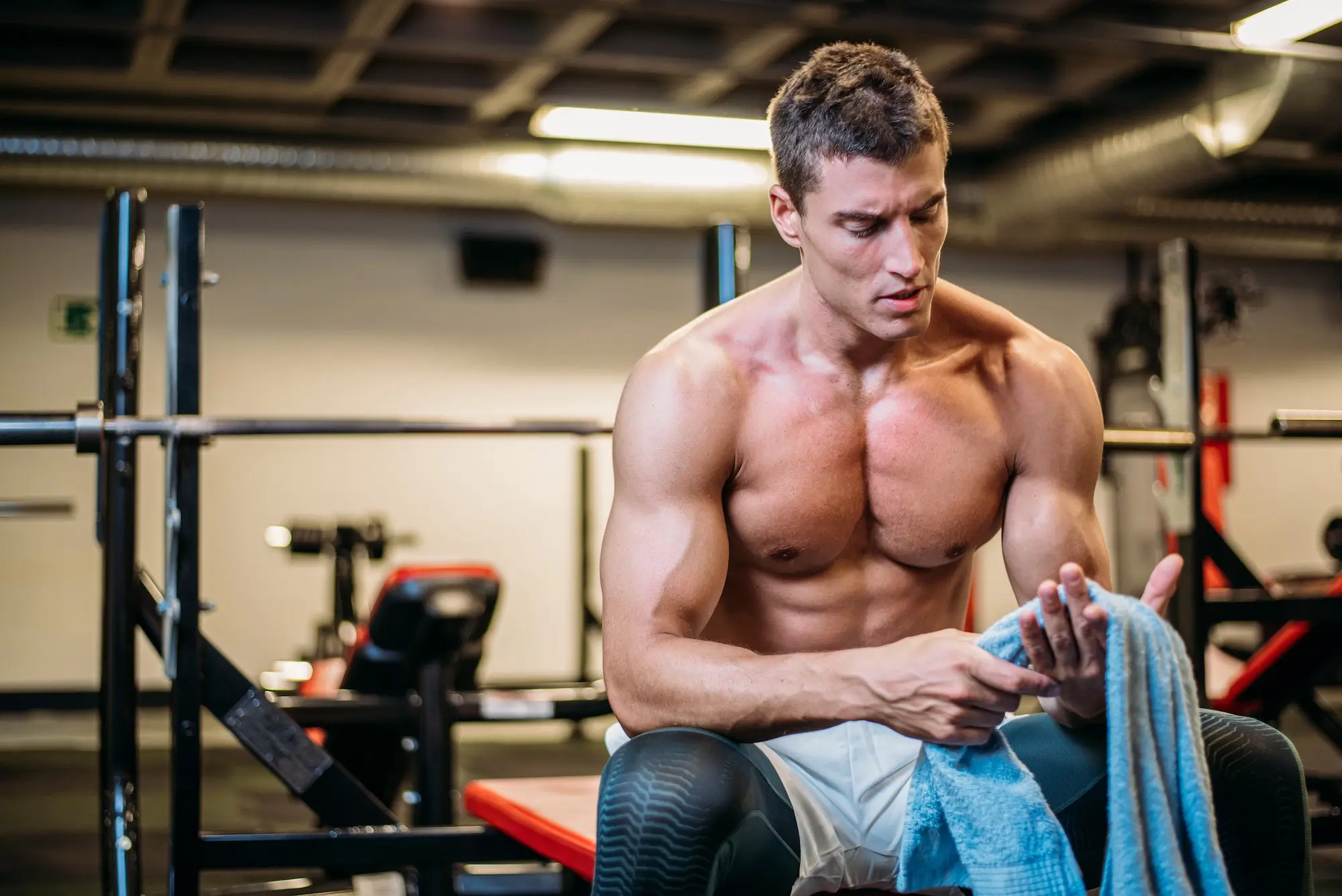 Muscular bodybuilder with towel